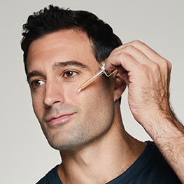 photo of man applying skincare