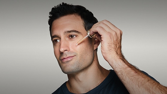 photo of man applying skincare
