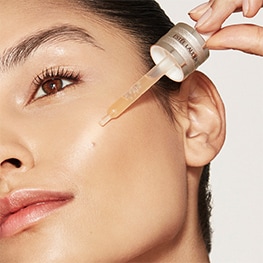 photo of woman applying estee lauder morning skincare routine