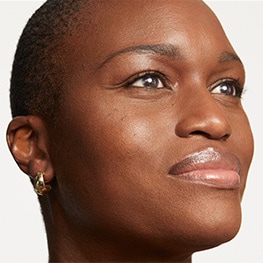 Woman with glowing skin looks into distance