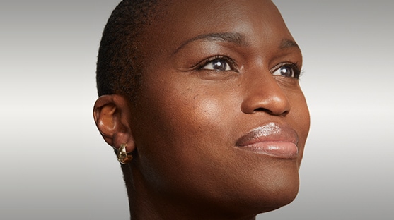 Woman with glowing skin looks into distance