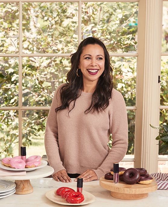 Recipe blogger Adriana Adarme of A Cozy Kitchen surrounded by sweet treats