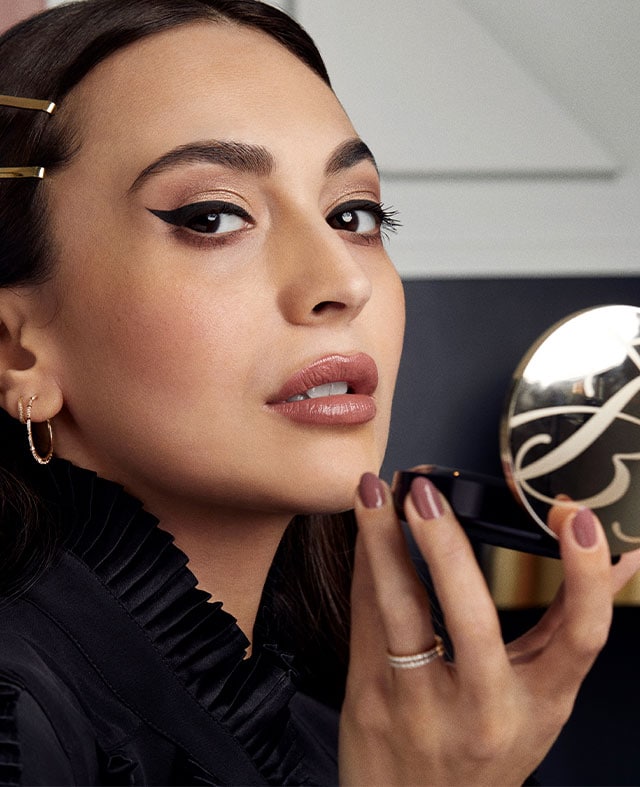 Zara Martin applying makeup