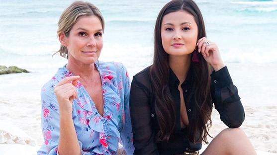 Aerin Lauder and blogger Peony Lim sit together on a tropical beach