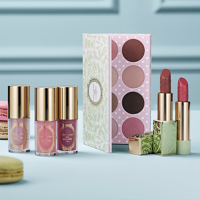 AERIN Rose Cocoa Perfume surrounded by pink roses