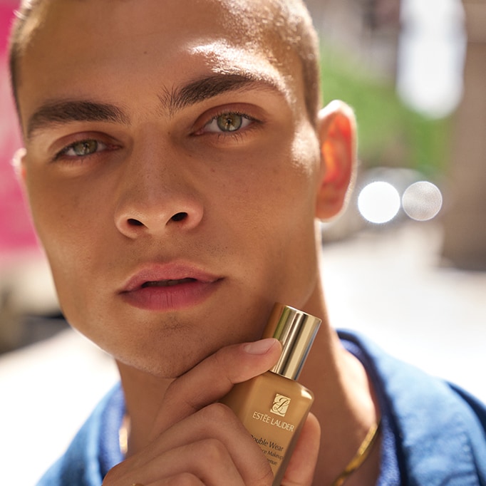 Male model with a Double Wear bottle