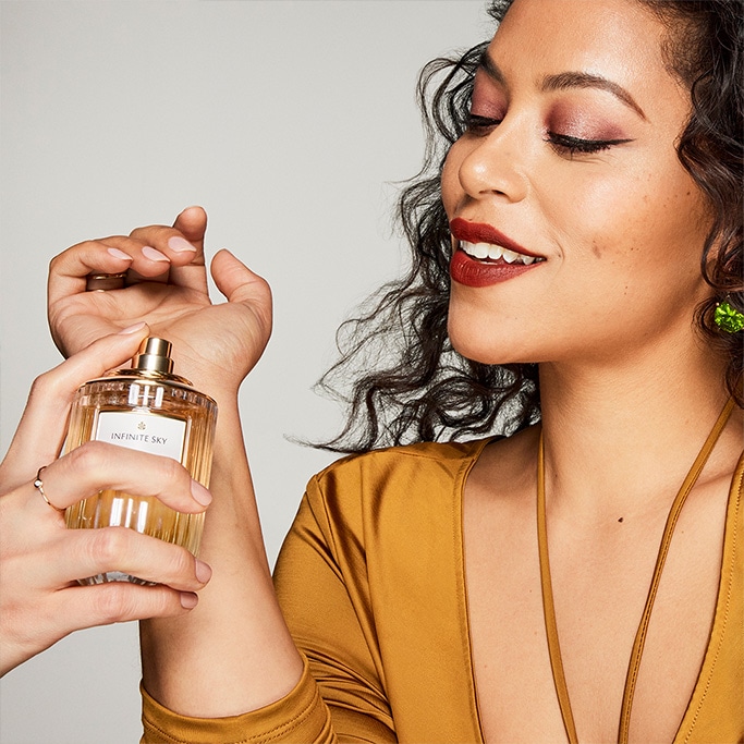 An image of a woman experiencing an Estée Lauder luxury fragrance